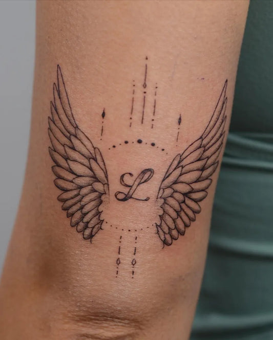 Small Geometric Angel Wings L Tattoo on Women Arm by @bobbymaytattoo