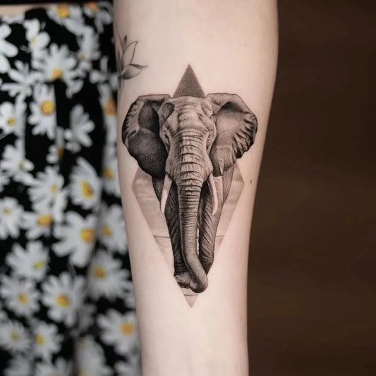 Small Geometric Elephant Tattoo on Women Upper Arm by @thommesen_ink