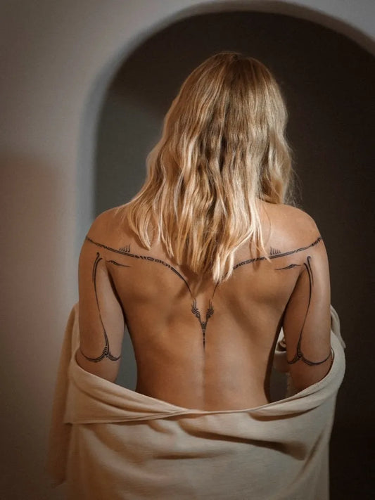 Small Geometric Lines on Women Back Tattoo by @sue.real