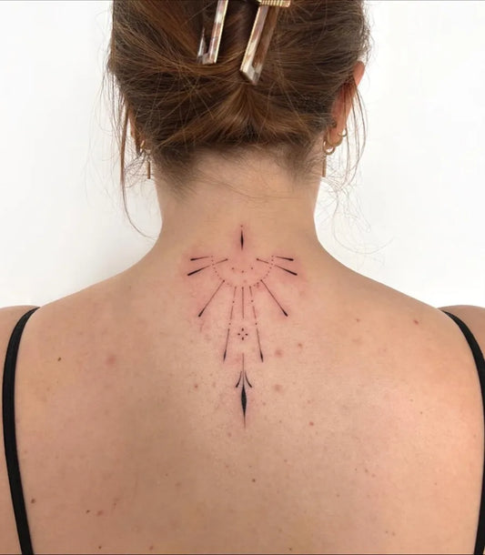 Small Geometric Sunburst on Women Back Tattoo by @fritzi.tattoo