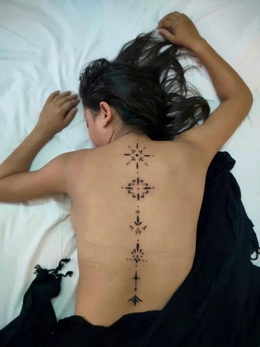 Small Geometric Symbols on Women Back Tattoo by @emkay_tattoos