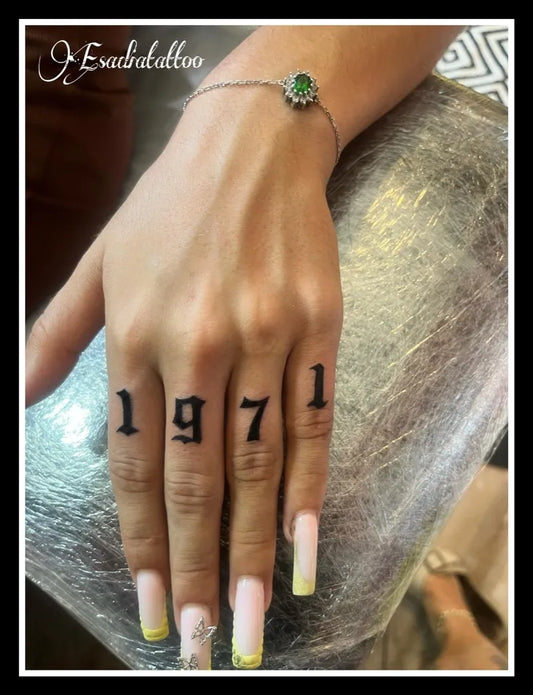 Small Gothic 1971 Numbers on Women Fingers Tattoo by @esadiatattoo