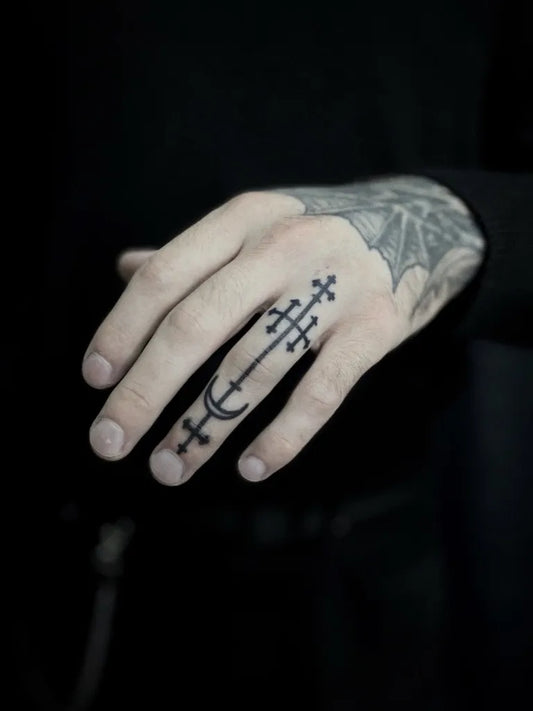 Small Gothic Cross and Crescent Tattoo on Men Finger by @cloverpoke