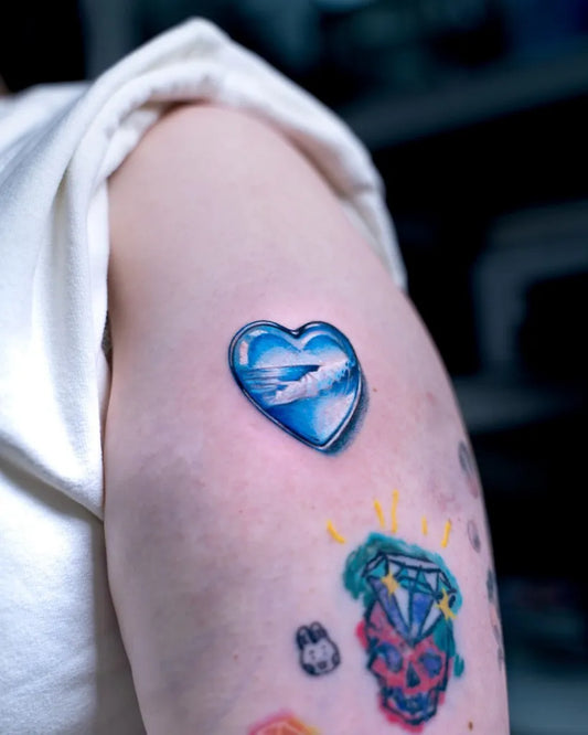 Small Illusion Heart with Bird on Women Arm Tattoo by @q.lee_tattoo