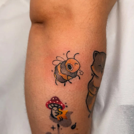 Small Illustrative Bee Mushroom Otter on Women Arm Tattoo by @giro.ink