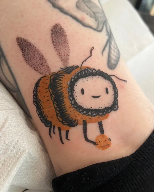 Small Illustrative Bee with Flower on Women Arm Tattoo by @funky_boy_tattoo