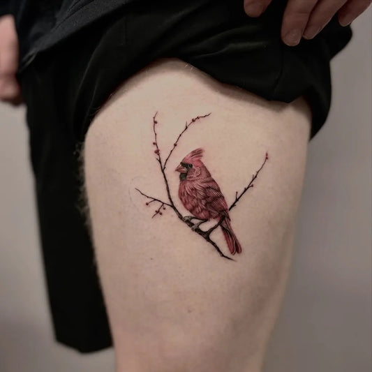 Small Illustrative Cardinal Branch Tattoo on Men Thigh by @sierra.inked