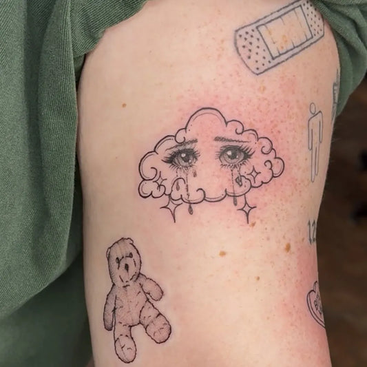 Small Illustrative Cloud with Tears and Teddy Bear Tattoo on Women Arm by @stlouistattoo