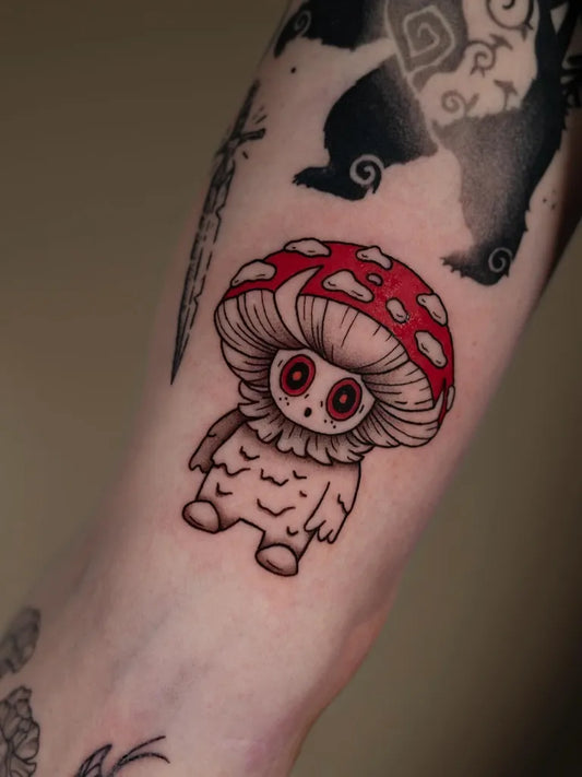 Small Illustrative Cute Mushroom Monster on Women Arm Tattoo by @forestwitch_bowien