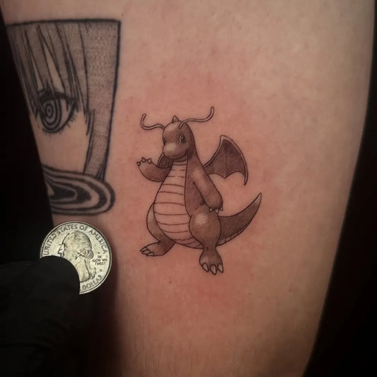 Small Illustrative Dragonite Pokemon Tattoo on Men Arm by @tattoopokedex