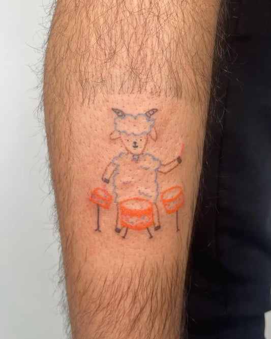 Small Illustrative Drumming Sheep Tattoo on Men Arm by @babbygail_doodles