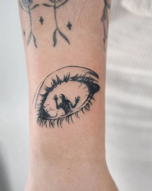 Small Illustrative Eye with Figure Women Arm by @_nono_tattoo