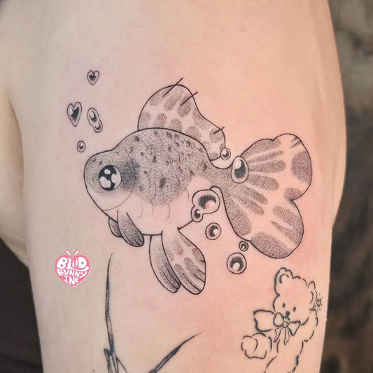 Small Illustrative Fish and Bear Tattoo on Women UpperArm by @bloodbunnyink