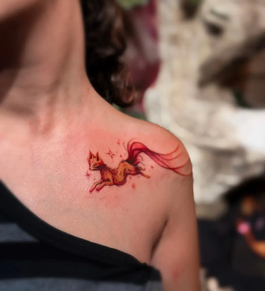 Small Illustrative Fox with Stars and Tail Tattoo on Women Shoulder by @edelvays_ink