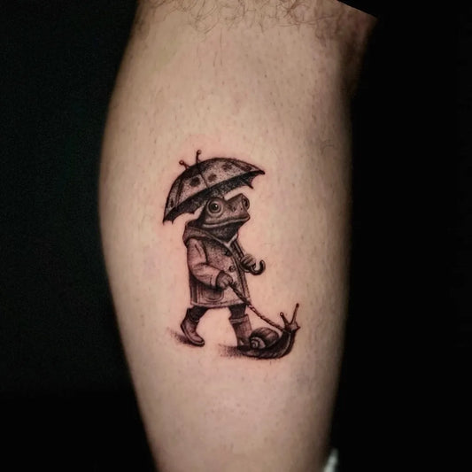 Small Illustrative Frog with Umbrella and Snail Tattoo on Men Leg by @tugbakeskink