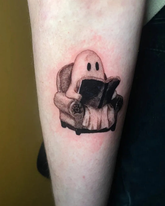 Small Illustrative Ghost Reading Tattoo on Women Arm by @zachnientattoos