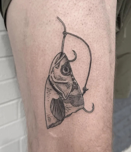 Small Illustrative Hanging Fish Tattoo on Men Thigh by @kaceltattoos