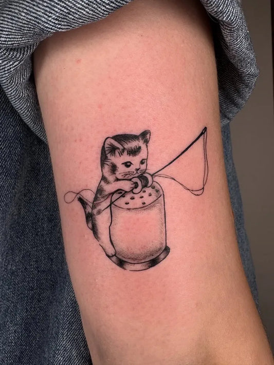 Small Illustrative Kitten Fishing Spools Tattoo on Women Arm by @livluvstab