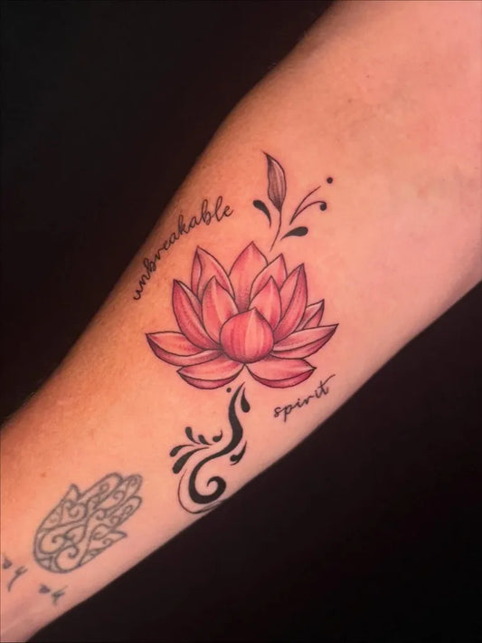 Small Illustrative Lotus Flower with Script on Women Arm Tattoo by @killakate_tattoos