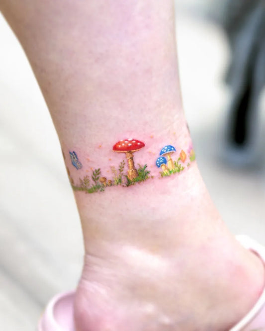 Small Illustrative Mushroom Butterfly Grass on Women Ankle Tattoo by @tat.soy