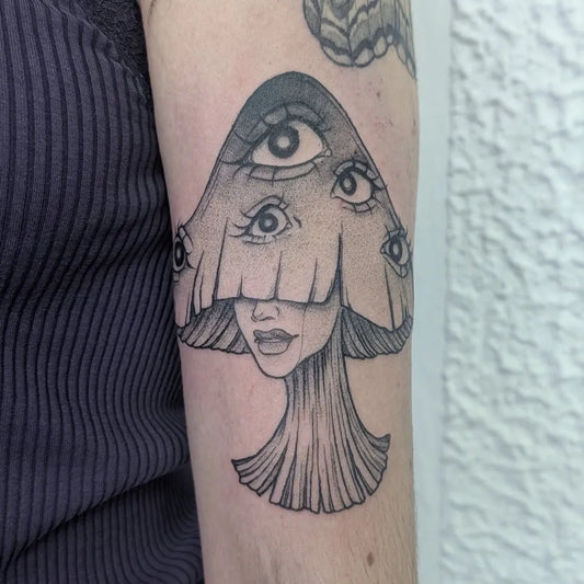 Small Illustrative Mushroom with Eyes and Face on Women Arm Tattoo by @artbymoeh