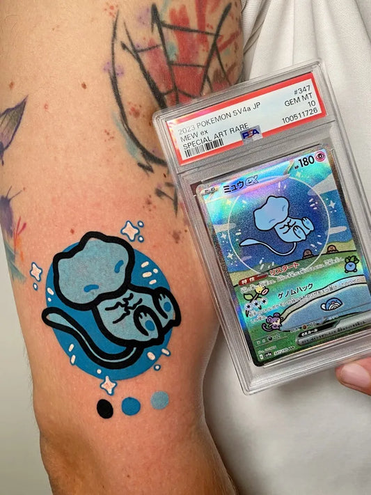 Small Illustrative Pokemon Mew Tattoo on Women Arm by @mambotattooer