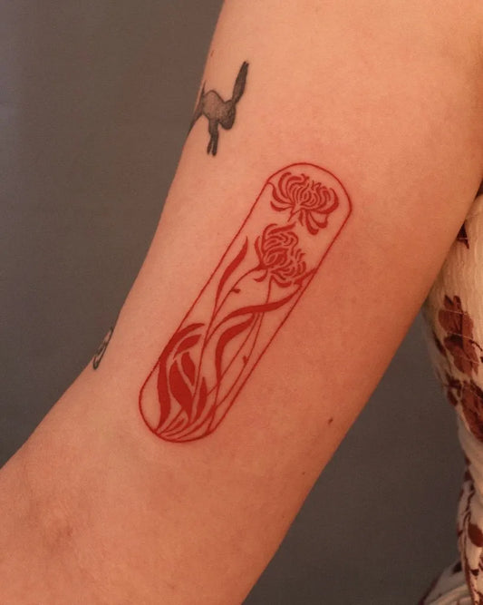 Small Illustrative Red Chrysanthemum and Leaves Tattoo on Women Arm by @wabisabi_ttt
