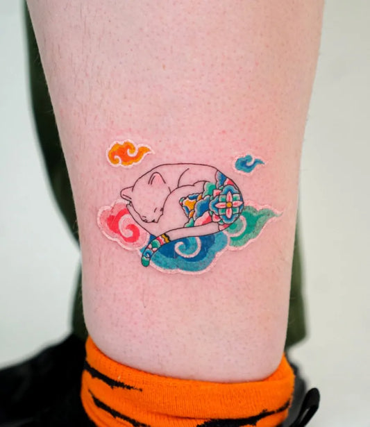 Small Illustrative Sleeping Cat with Flower Cloud Tattoo on Women Leg by @stroke.hwizi_tt
