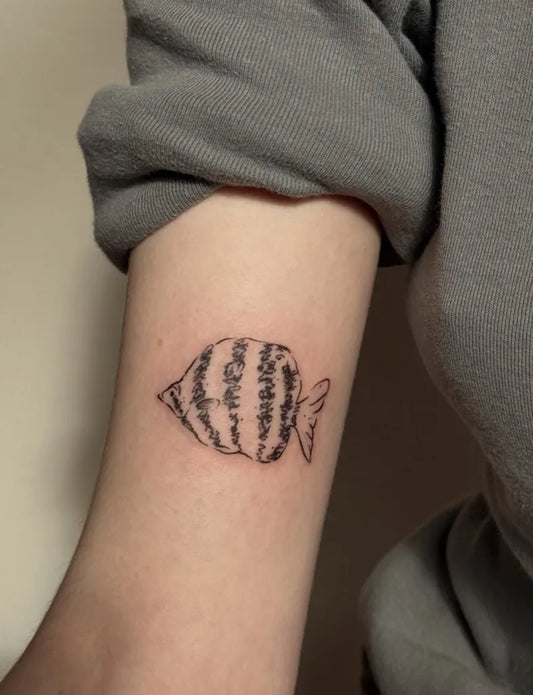 Small Illustrative Striped Angelfish Tattoo on Women Arm by @stinky.tatts