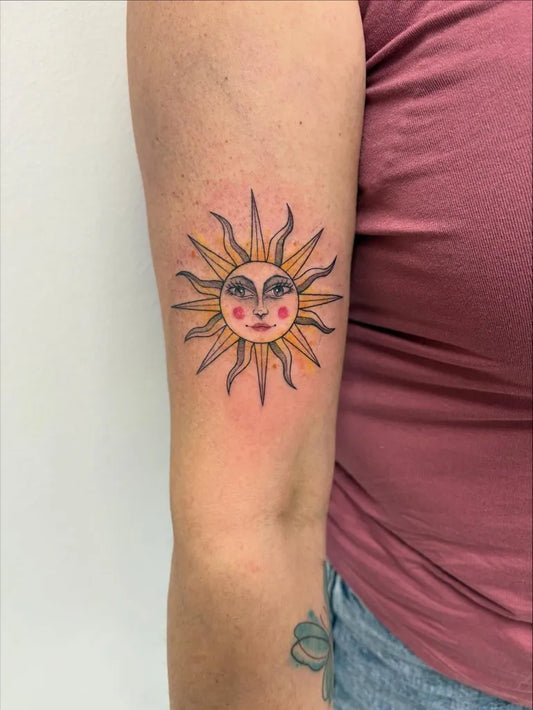 Small Illustrative Sun with Face on Women Arm Tattoo by @isjaki.ink