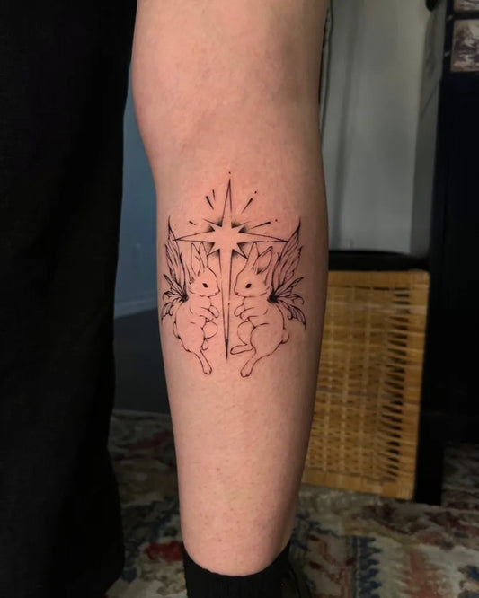 Small Illustrative Twin Winged Rabbits Tattoo on Women Leg by @sleepywoode
