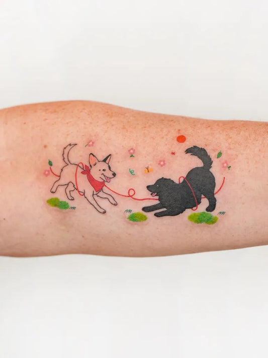 Small Illustrative Two Dogs Tattoo on Women Arm by @jebi.tattoo