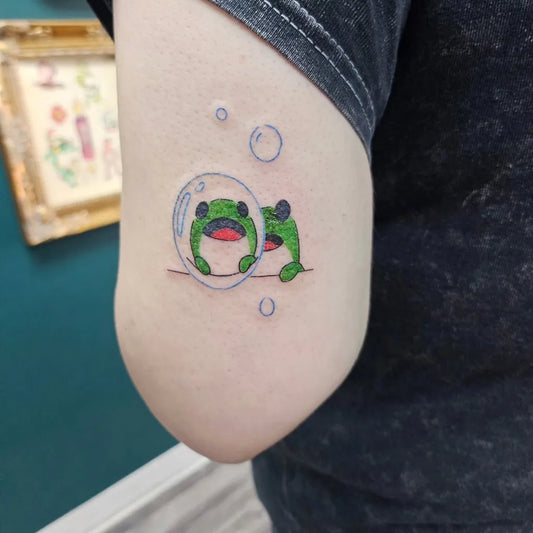 Small Illustrative Two Frogs in Bubbles Tattoo on Women Arm by @inkyuli_tattoo