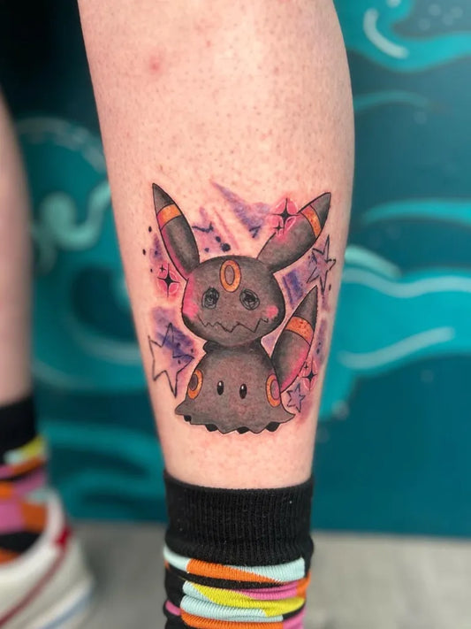 Small Illustrative Umbreon Pokemon Tattoo on Women Leg by @kerrylouutattoo