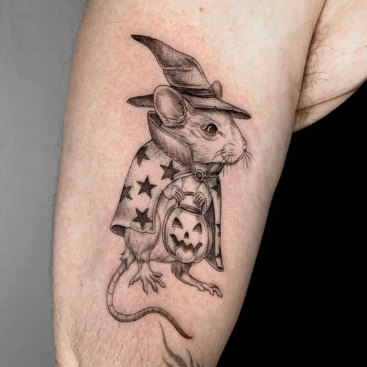 Small Illustrative Witch Mouse with Pumpkin Tattoo on Men Arm by @raecolliertattoo