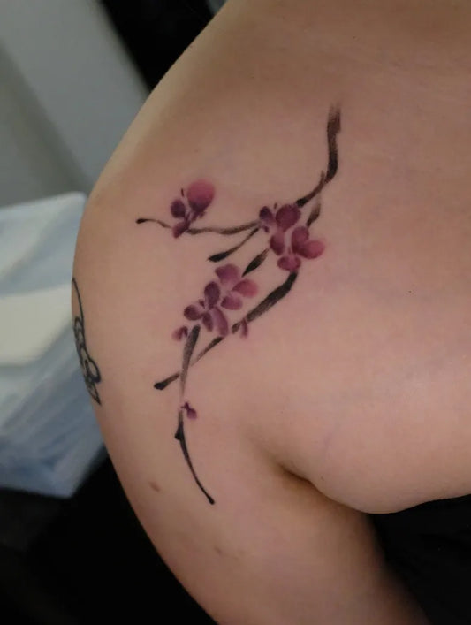 Small Japanese Cherry Blossom Branch on Women Shoulder Tattoo by @hayu.ink