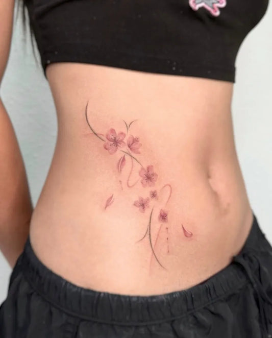 Small Japanese Cherry Blossom Branches on Women Waist Tattoo by @pomaikai.artistry