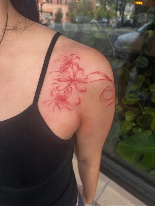 Small Japanese Red Spider Lily Tattoo on Women Shoulder by @desertcat.tattoo