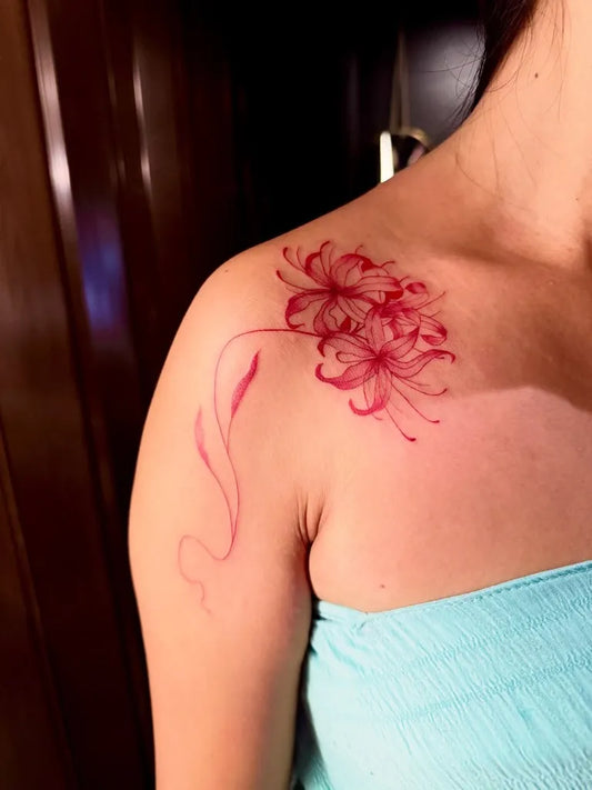 Small Japanese Spider Lily Red Tattoo on Women Shoulder by @chachadaiz