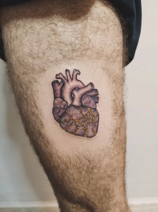 Small Kintsugi Heart on Men Thigh Tattoo by @studio220_tattoo