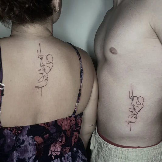 Small Line Art Face and Hand on Couple Back and Side Matching Tattoo by @arte_su_pelle