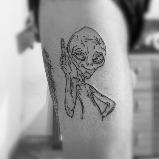 Small Linework Alien Showing Middle Finger Tattoo on Women Arm by @aliqpila.23