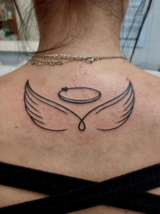 Small Linework Angel Wings Halo Tattoo on Women Back by @dermotinta