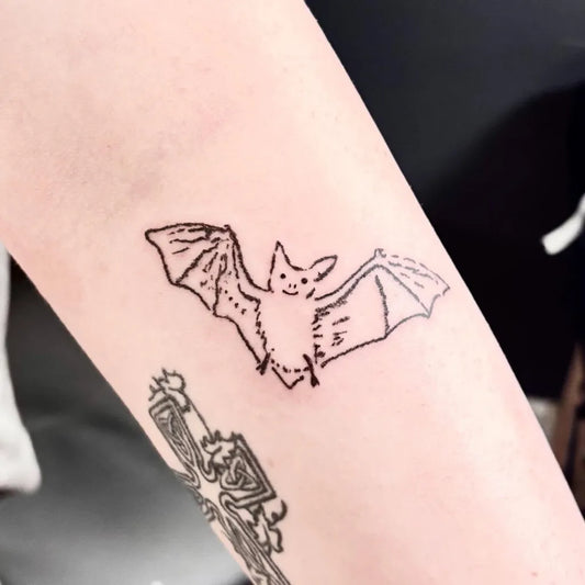Small Linework Bat Tattoo on Women Arm by @beansprout_tattoo