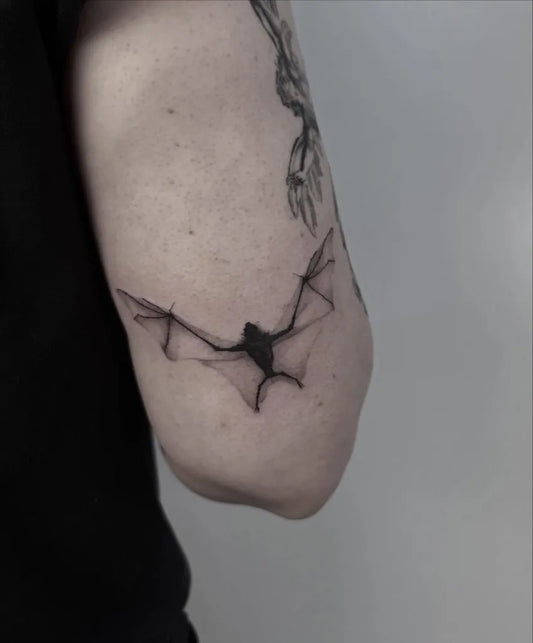 Small Linework Bat Tattoo on Women Arm by @hellishxtattoos