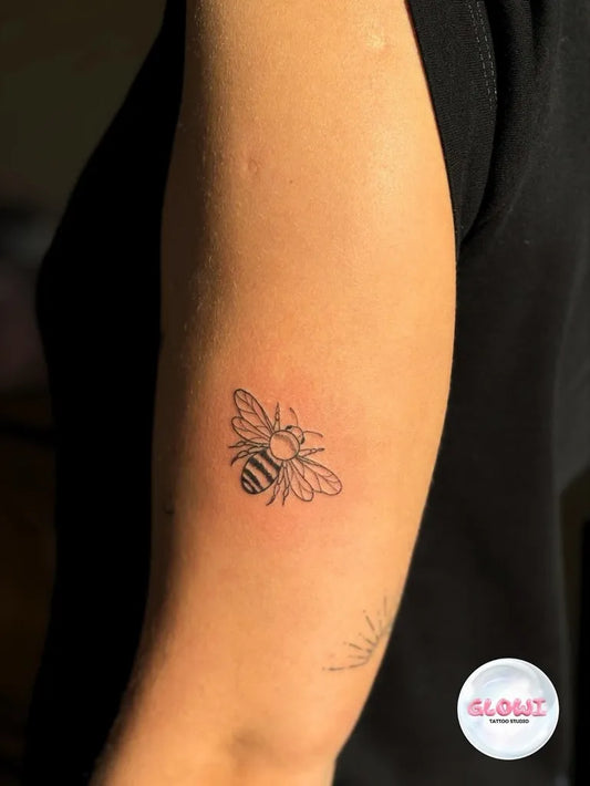 Small Linework Bee on Women Arm Tattoo by @glowi.tattoo