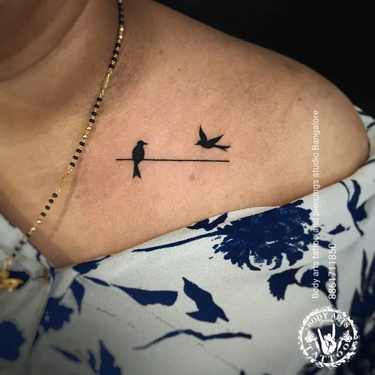 Small Linework Birds on Wire Tattoo on Women Collarbone by @bodyarts_blr