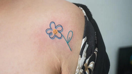 Small Linework Blue Daisy Tattoo on Women Shoulder by @theplasticmoon