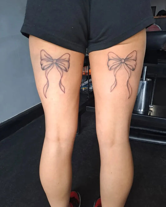 Small Linework Bow on Women Thigh Tattoo by @whelantattoo