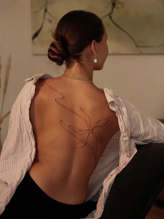 Small Linework Butterfly on Women Back Tattoo by @naomi.tattoo